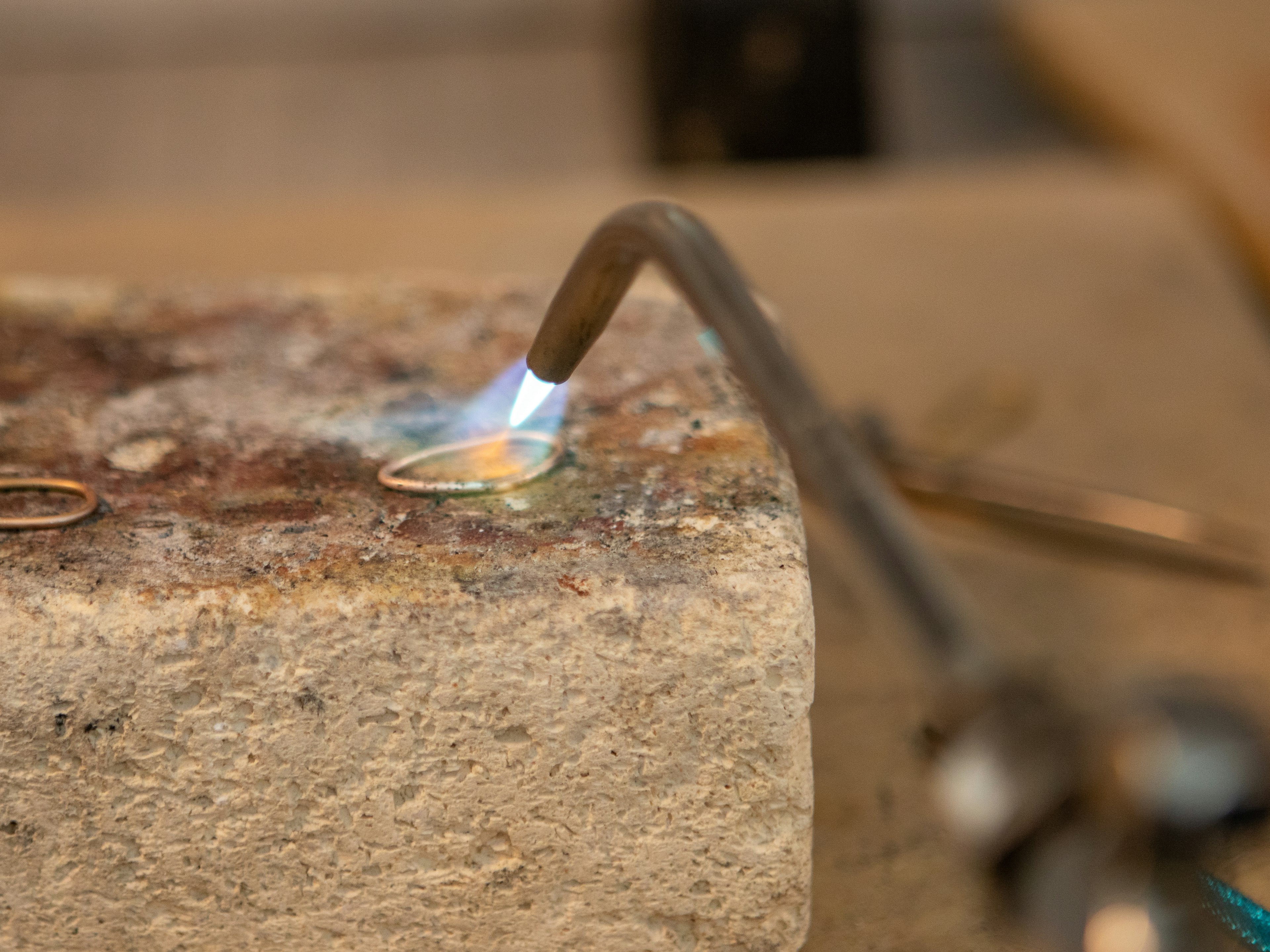 A jeweler handcrafting a ring at Saleh Jewelers